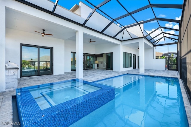 view of pool with ceiling fan, a patio area, and a lanai