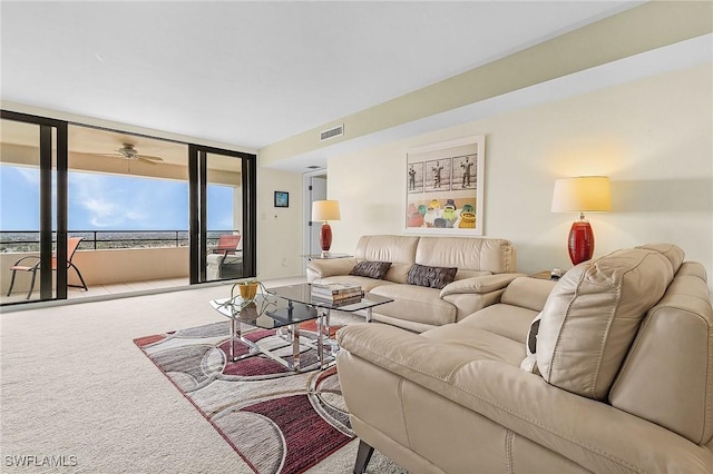 carpeted living area with expansive windows and visible vents