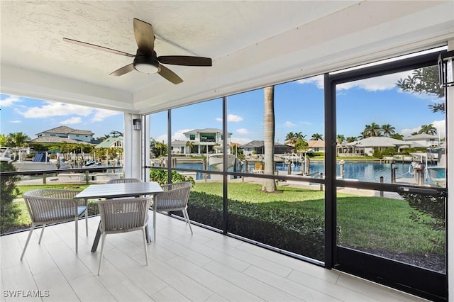 880 Huron Ct Unit 107, Marco Island, FL 34145 - sunroom / solarium featuring a water view, ceiling fan, a wall of windows, and a residential view
