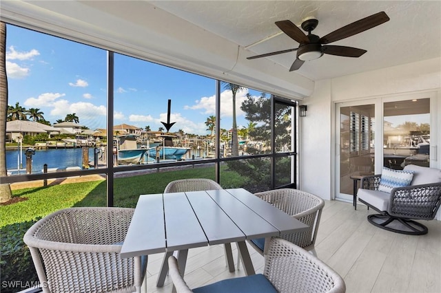 880 Huron Ct Unit 107, Marco Island, FL 34145 - sunroom featuring ceiling fan and a water view
