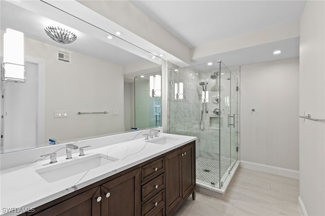 880 Huron Ct Unit 107, Marco Island, FL 34145 - bathroom featuring recessed lighting, baseboards, a marble finish shower, and double vanity