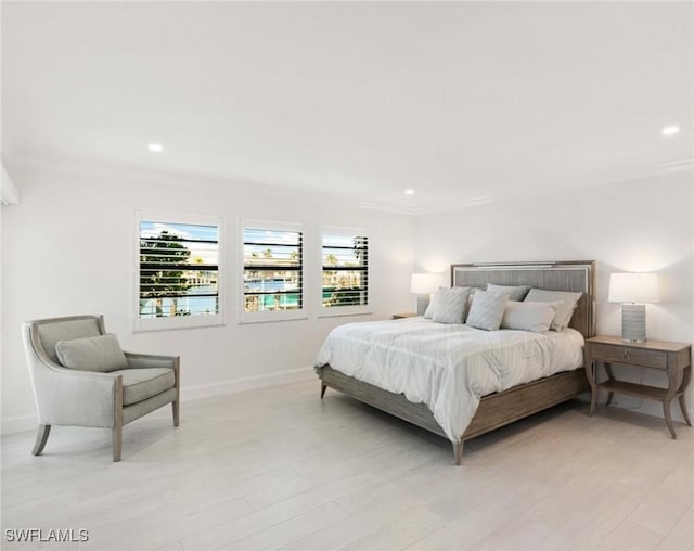 880 Huron Ct Unit 107, Marco Island, FL 34145 - bedroom with baseboards, light wood-type flooring, recessed lighting, and crown molding