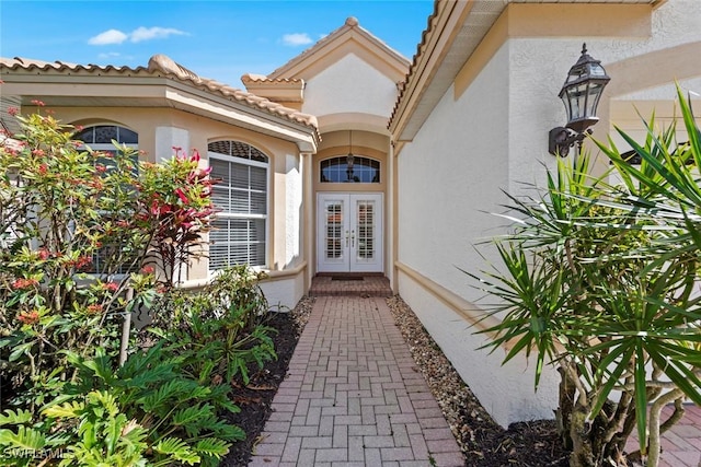 entrance to property with a tiled roof and stucco siding