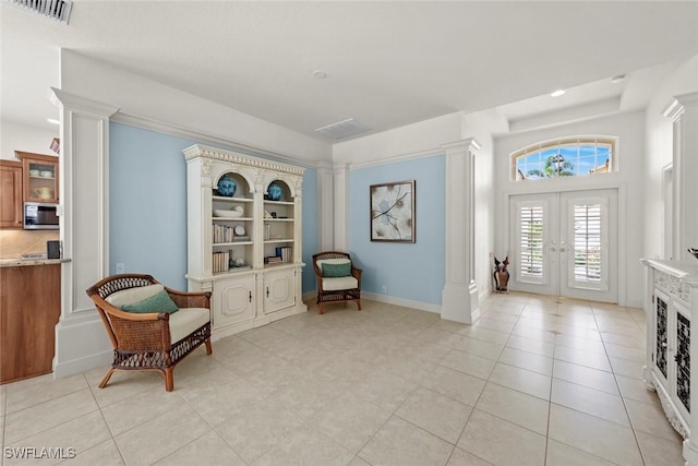 living area with french doors, decorative columns, light tile patterned floors, recessed lighting, and visible vents