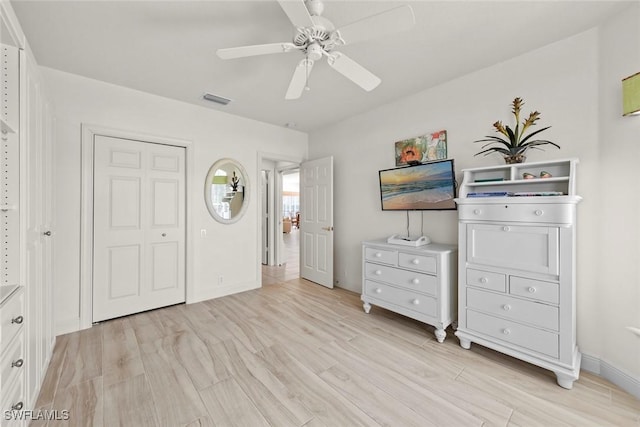 unfurnished bedroom with ceiling fan, visible vents, baseboards, a closet, and light wood finished floors