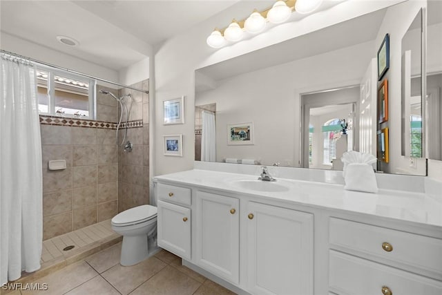 full bathroom with toilet, tile patterned flooring, a shower stall, and vanity