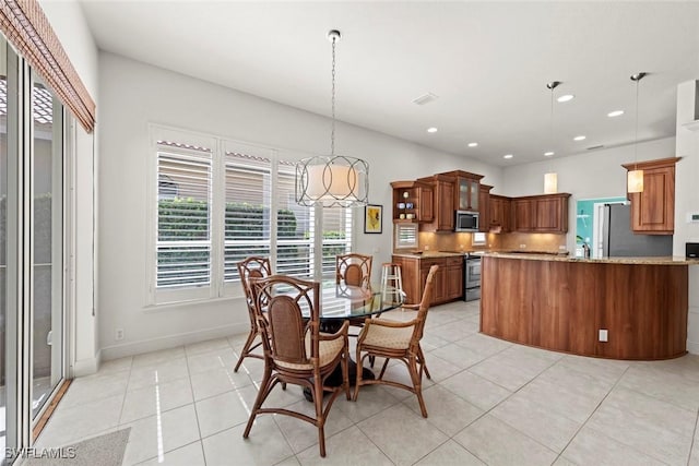 dining space featuring light tile patterned floors, baseboards, and recessed lighting