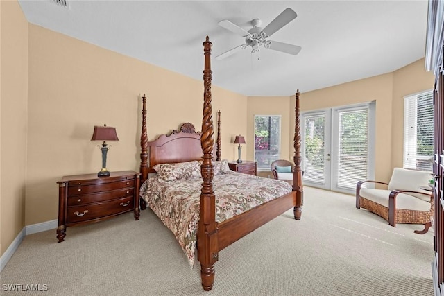 bedroom featuring baseboards, a ceiling fan, light colored carpet, and access to exterior