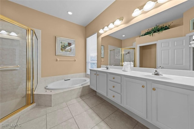 bathroom with double vanity, a sink, a shower stall, a bath, and tile patterned floors