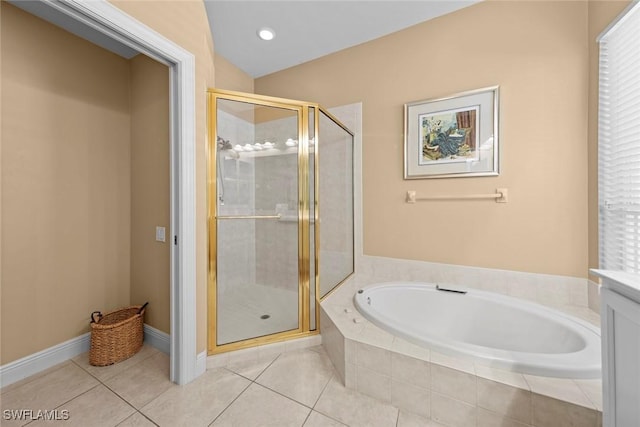 bathroom with tile patterned flooring, vanity, a bath, and a shower stall