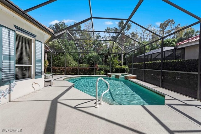 view of pool with a pool with connected hot tub, a lanai, and a patio