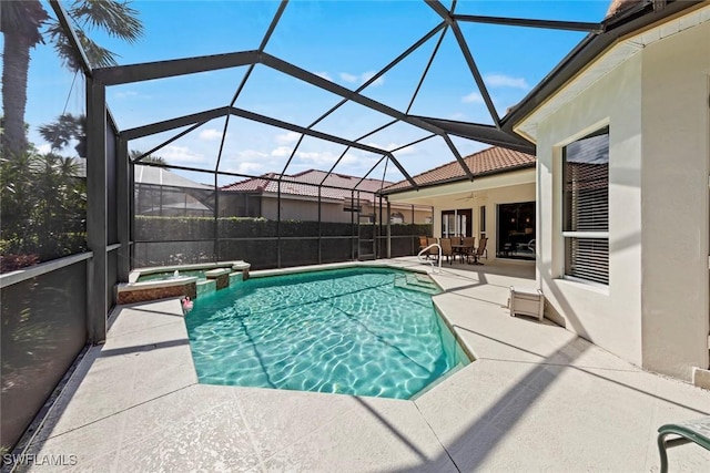 view of swimming pool featuring a patio area, a lanai, and a pool with connected hot tub