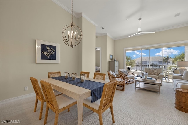 dining area with light colored carpet, visible vents, a high ceiling, ornamental molding, and baseboards