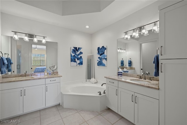 full bath featuring two vanities, tile patterned flooring, and a sink