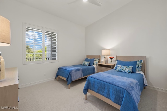 bedroom featuring a ceiling fan, lofted ceiling, light colored carpet, and baseboards