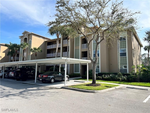 view of building exterior featuring covered parking