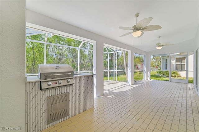 unfurnished sunroom with a wealth of natural light and ceiling fan