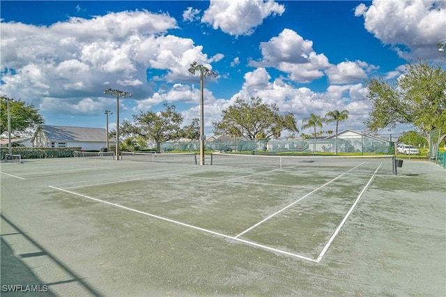 view of tennis court with fence