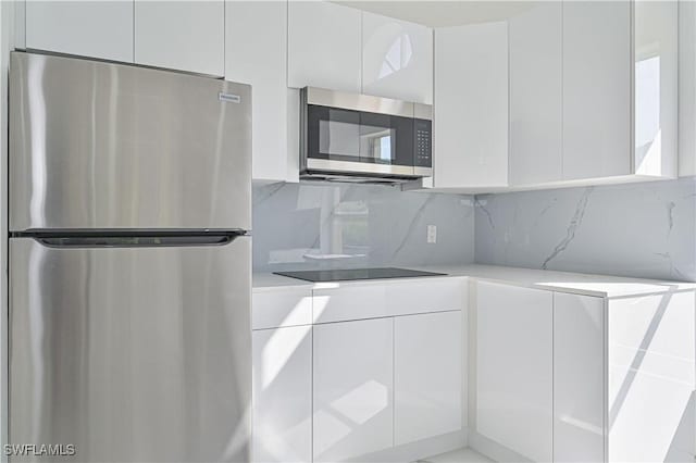 kitchen featuring appliances with stainless steel finishes, white cabinets, and modern cabinets