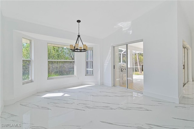 dining space featuring marble finish floor, baseboards, and a chandelier