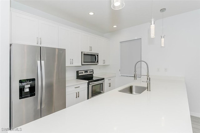 kitchen with stainless steel appliances, light countertops, and white cabinetry