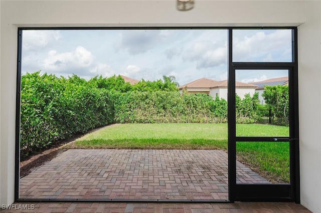 doorway to outside featuring brick floor and plenty of natural light