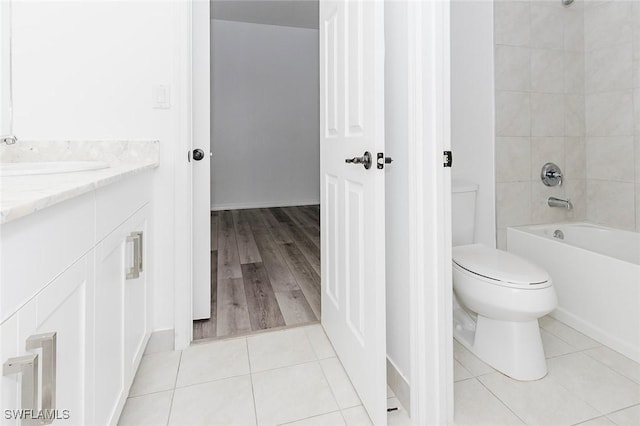 bathroom with bathing tub / shower combination, vanity, toilet, and tile patterned floors