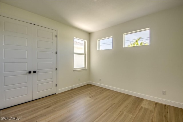 interior space with light wood finished floors and baseboards