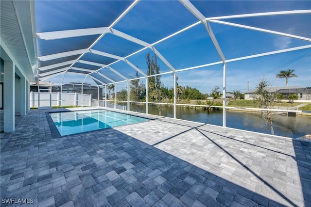 outdoor pool with a patio, a water view, and a lanai