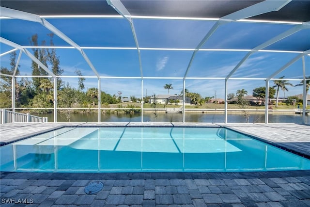 pool featuring a patio area, a lanai, and a water view