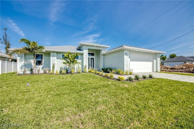 view of front of property with a front yard, driveway, an attached garage, and fence