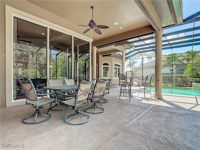 view of patio with ceiling fan, a lanai, and a fenced in pool