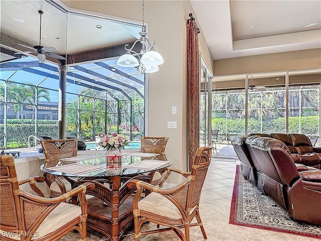 interior space with ceiling fan with notable chandelier, light tile patterned floors, and a sunroom