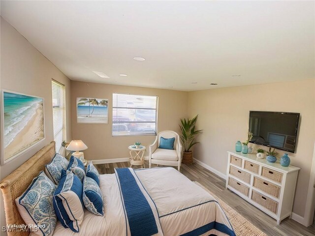 bedroom featuring wood finished floors and baseboards