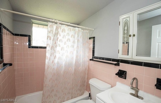 full bath featuring vanity, tile walls, toilet, and shower / bath combo with shower curtain