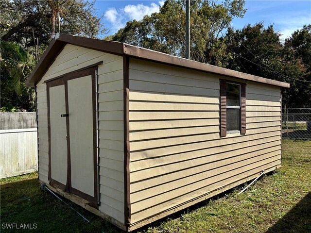 view of shed with fence