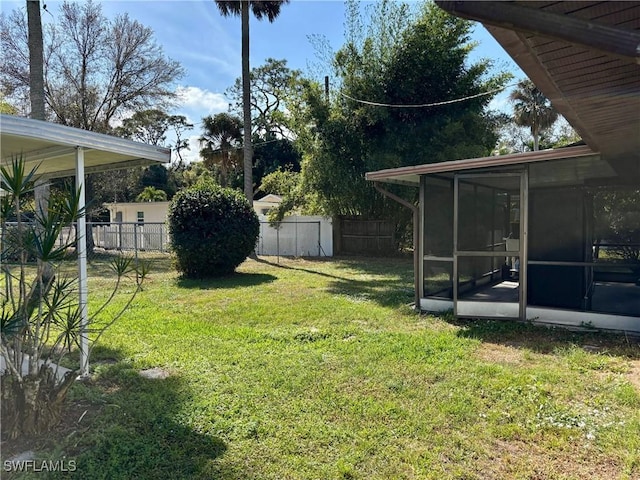 view of yard featuring a fenced backyard and a sunroom