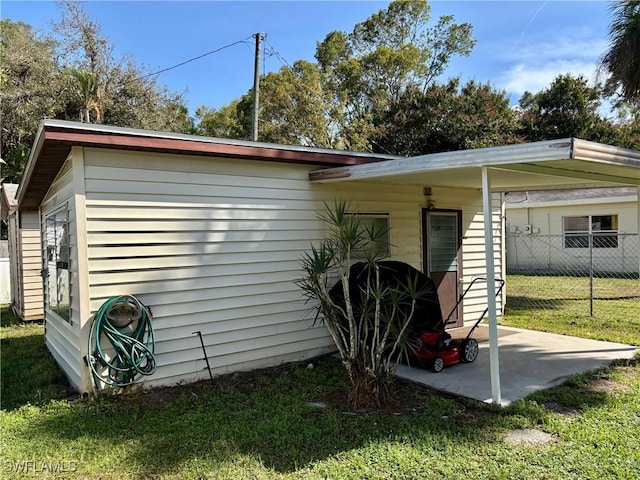 view of property exterior featuring a lawn and fence