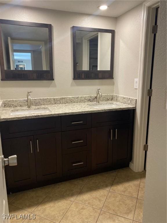 bathroom with double vanity, tile patterned flooring, a sink, and recessed lighting