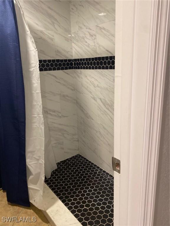 bathroom with a tile shower