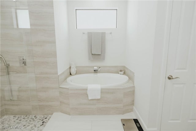 bathroom featuring a closet, a shower stall, a bath, and tile patterned floors