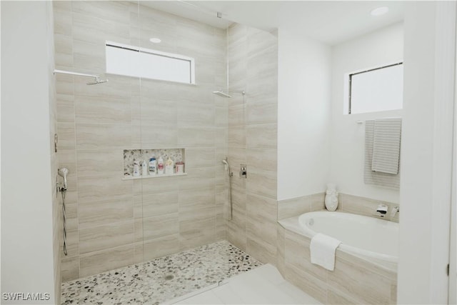 full bathroom with a tile shower and a garden tub