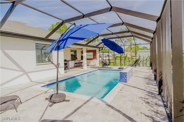 pool with a lanai, a patio area, and outdoor dry bar