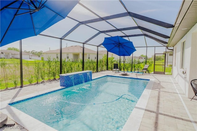 pool with glass enclosure, a patio, and a hot tub