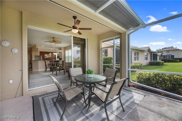 sunroom featuring ceiling fan