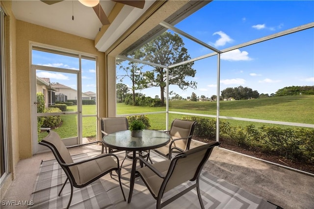 sunroom featuring a ceiling fan