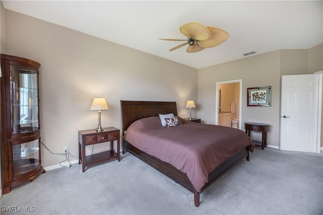 bedroom with ceiling fan, connected bathroom, light carpet, visible vents, and baseboards