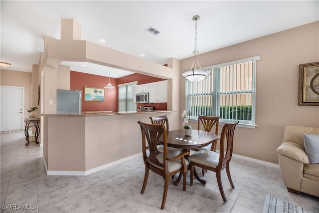 dining room featuring light tile patterned floors, visible vents, baseboards, and recessed lighting