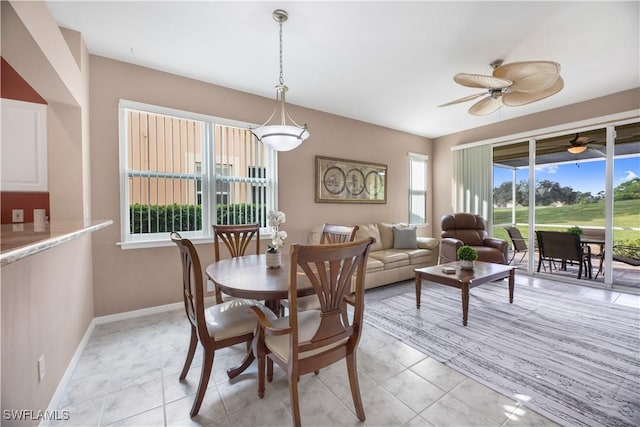 dining room with light tile patterned flooring, baseboards, and ceiling fan