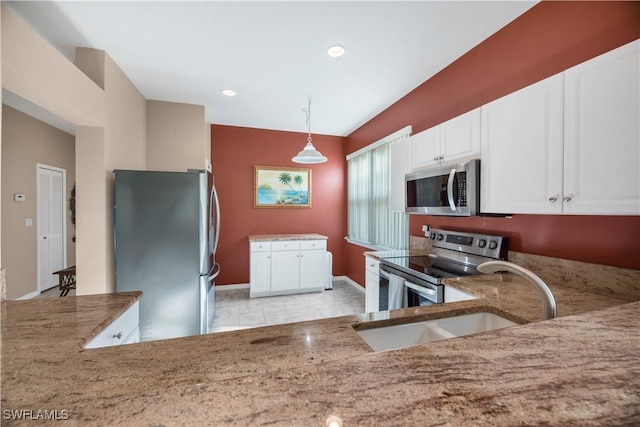 kitchen featuring a sink, stainless steel appliances, light stone countertops, and white cabinets